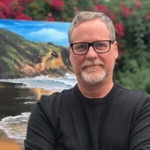 Randall Holbrook in front of painting of the Dana Point Headlands